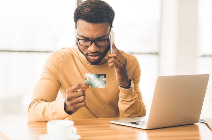 fraud credit card shocked man