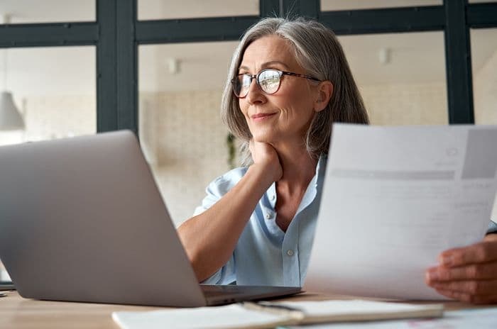 older woman working at computer