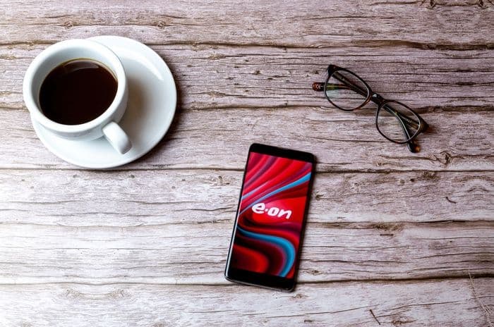 eon energy on mobile with coffee